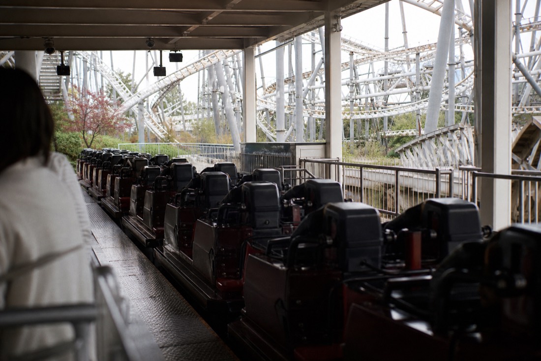 Coaster trains waiting in an open station at Fuji-Q Highland's thrill lineup