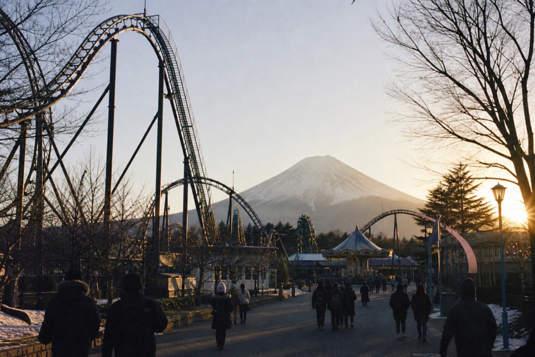 Fuji-Q Highland coaster silhouettes under a low winter afternoon sun with a thinning end-of-day crowd