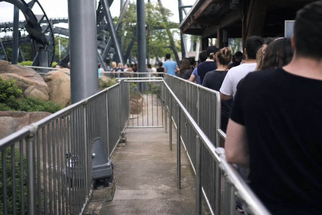 Short priority lane beside the long standby queue at a coaster entrance