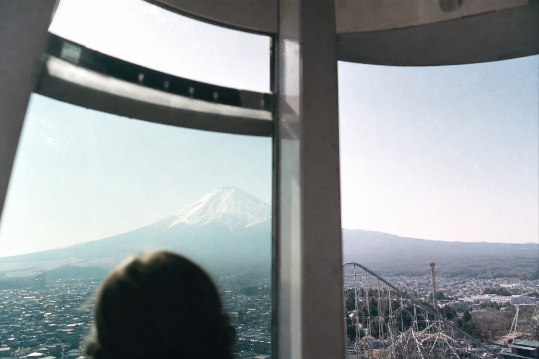 Ferris wheel view of Mount Fuji over Fuji-Q Highland through the gondola window