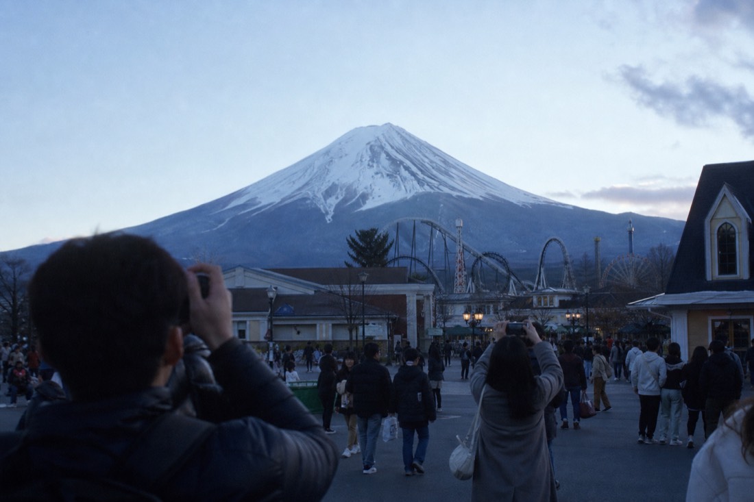 Visitors photographing Mount Fuji from the Fuji-Q Highland entrance plaza